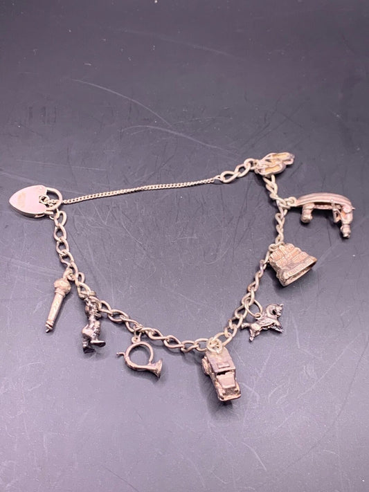 STERLING SILVER CHARM BRACELET - 9 SILVER CHARMS DONALD DUCT ETC.