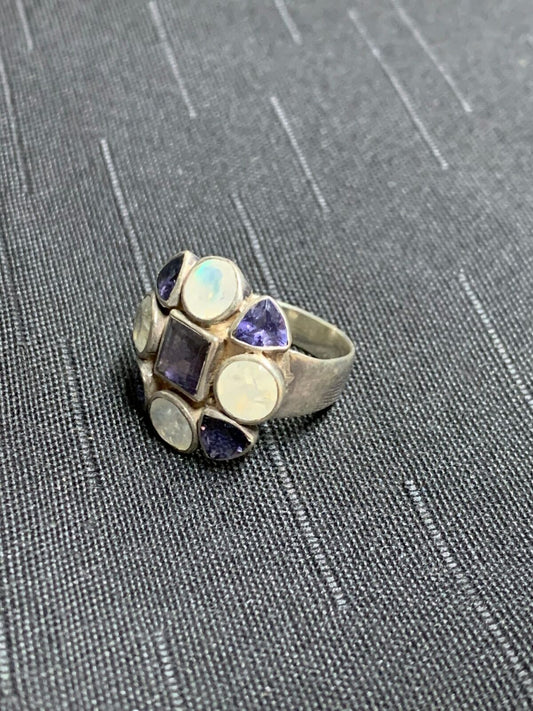 SILVER RING - UNKNOWN WHITE AND DEEP BLUE STONE SETTINGS