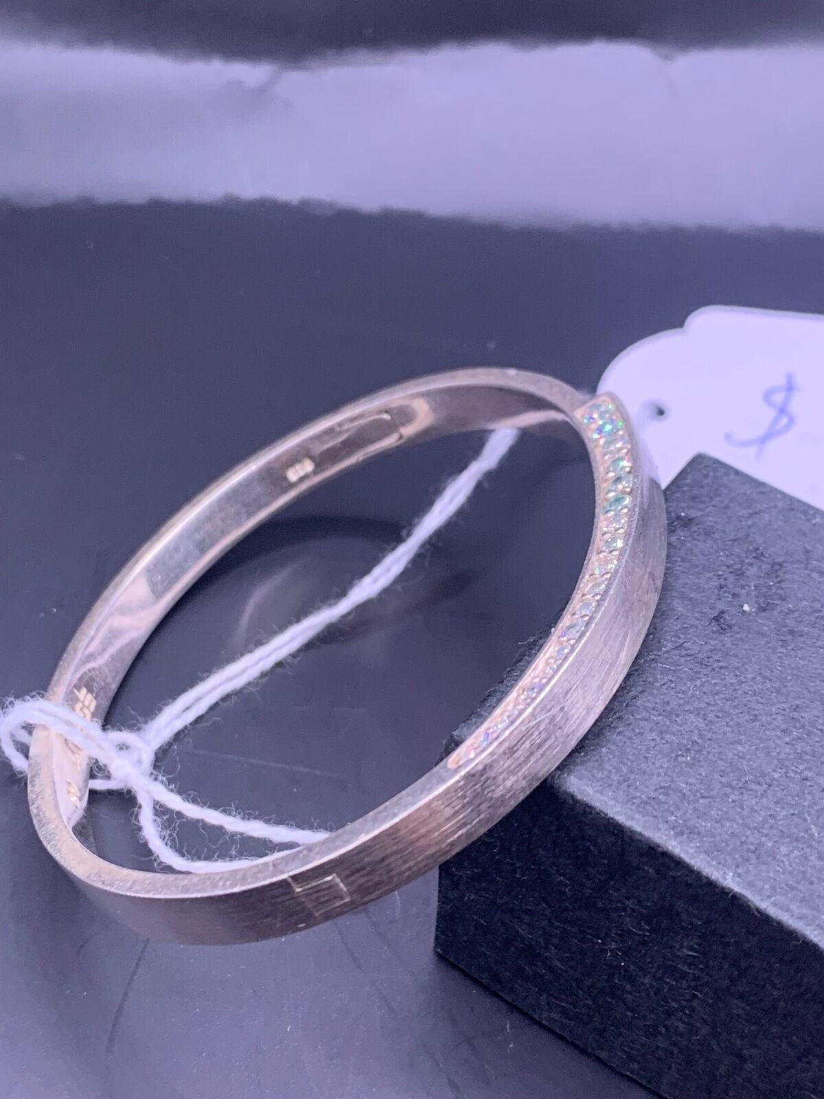 STERLING SILVER BANGLE - UNIDENTIFIED WHITE STONES AND FISH HOOK CLIP